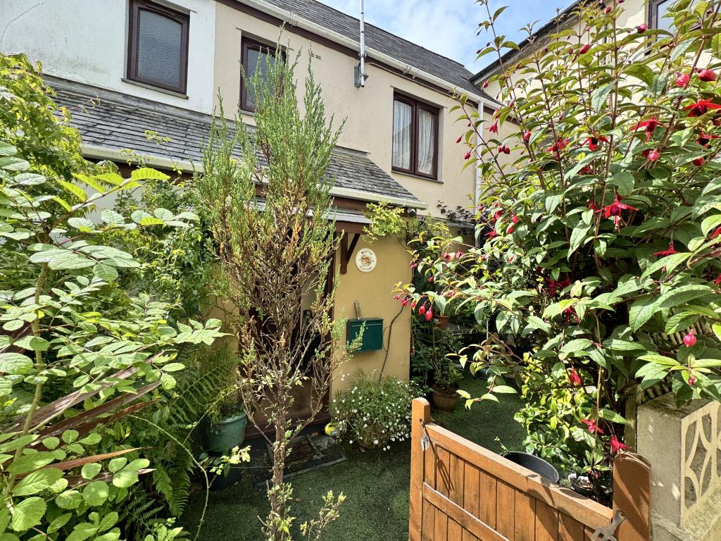 Lot: 101 - TWO-BEDROOM HOUSE FOR IMPROVEMENT IN VILLAGE LOCATION - Front of the cottage